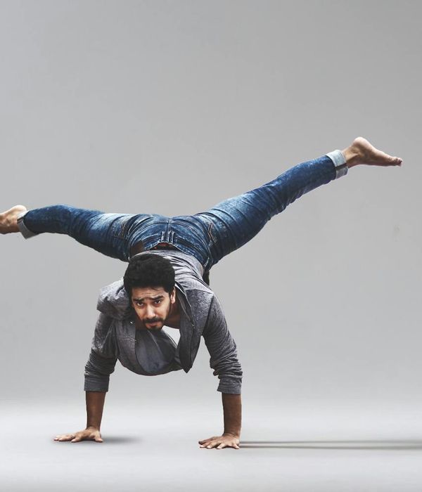 Man performing a controlled bodyweight exercise with a focused expression.